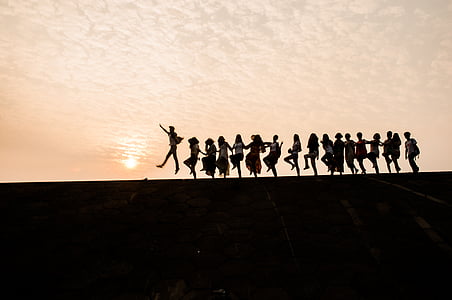 group of people in line during sunset thumbnail