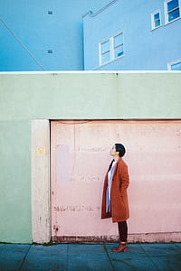 woman standing beside pink garage door thumbnail