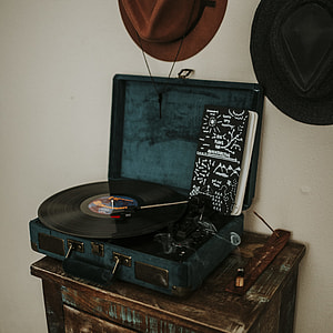 black vinyl record on blue turntable thumbnail