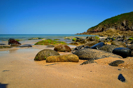 rocks near sea during daytime thumbnail