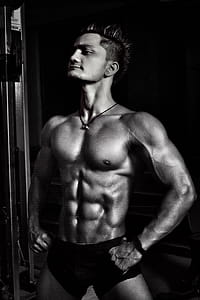 Grayscale Photography of Man in Short Standiung thumbnail