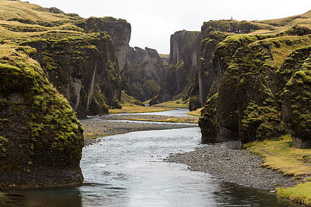 body of water near cliffs thumbnail