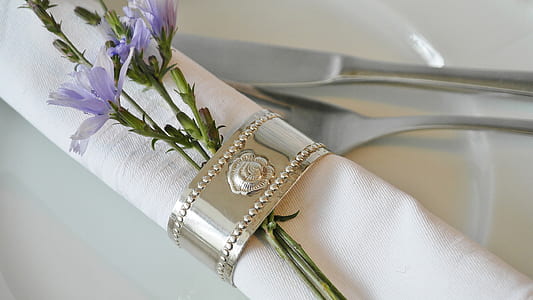 purple petaled flower clipped by silver-colored napkin ring thumbnail