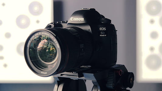 black Canon DSLR camera on tripod thumbnail