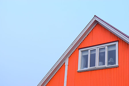 low-angle photography of red house under clear blue sky thumbnail