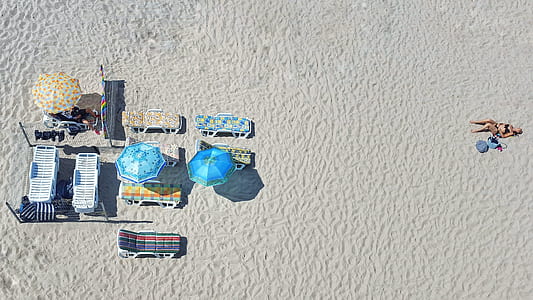 aerial photography of woman lying on sand thumbnail
