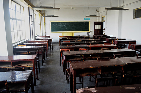 brown wooden desk near chalk board thumbnail