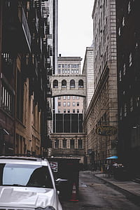 white Jeep Grand Cherokee on road side surrounded by high rise building thumbnail