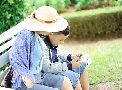 Woman With a Boy Sits on Bench thumbnail