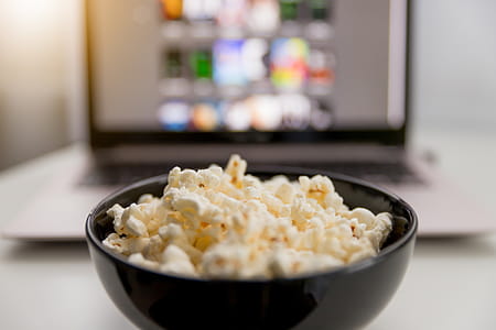 Watching movies online on laptop and eat popcorn. thumbnail