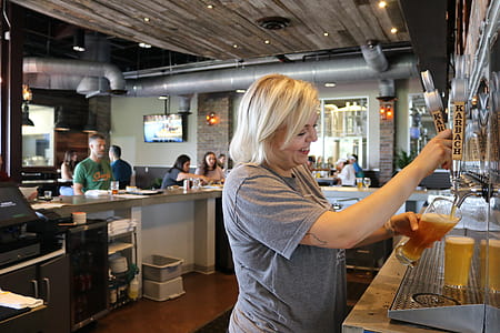 Woman Holding Clear Glass Cup thumbnail