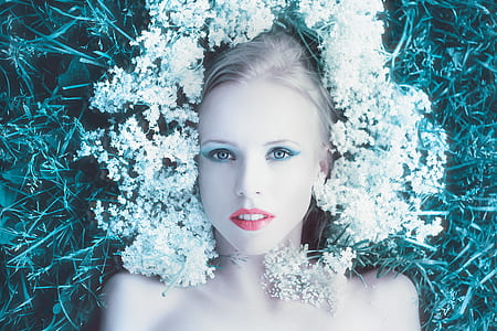 woman lying on the ground with flower all over her head thumbnail