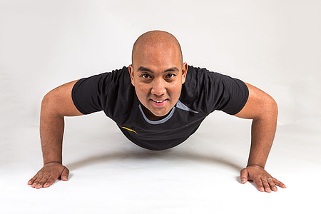 man doing push-up on white surface thumbnail