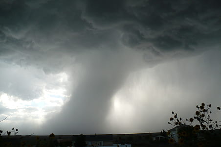 buildings and trees in distant of tornado thumbnail