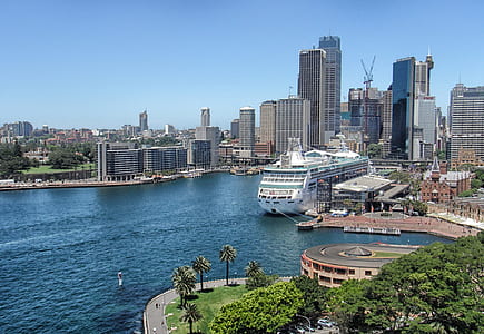 cruise ship at dock with city in background thumbnail