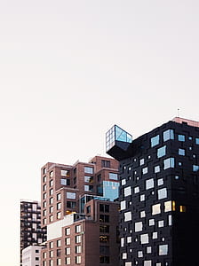 brown and black buildings under clear sky thumbnail