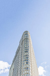 high rise concrete building under blue sky thumbnail