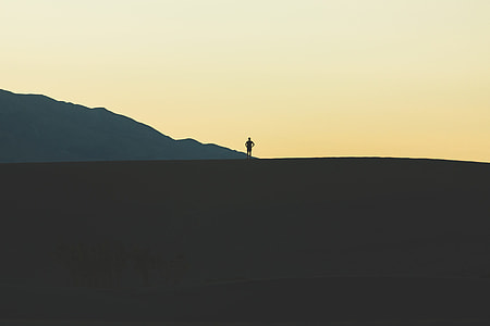 person standing mountain during daytime thumbnail