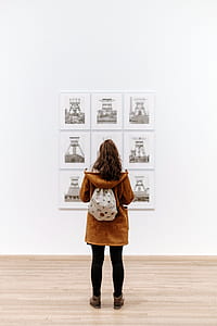 woman facing wall with backpack thumbnail