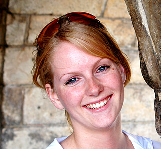 woman with sunglasses beside wall thumbnail