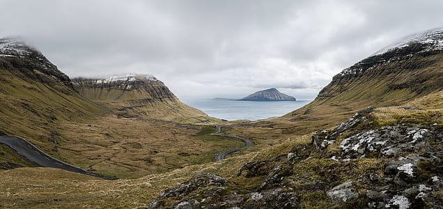 photo green mountain near ocean thumbnail