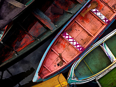 several canoed docked on sea dock thumbnail