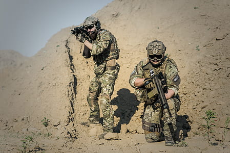 two soldiers with weapons at the field during day thumbnail
