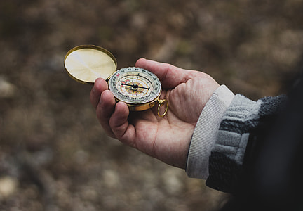 person holding compass thumbnail