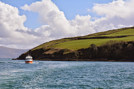 white and orange boat on body of water thumbnail