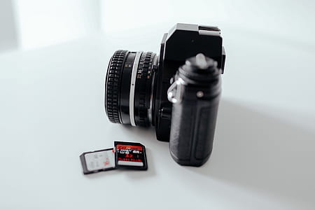 card readers beside black DSLR camera thumbnail