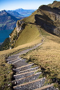 person walking on the mountain during daytime thumbnail