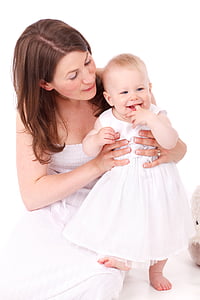 woman holding baby wearing dress thumbnail