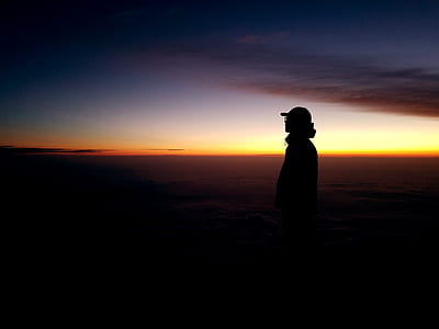 silhouette of person standing during golden hour thumbnail