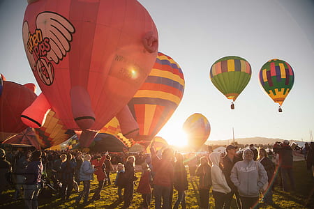 people standing near hot air balloons thumbnail