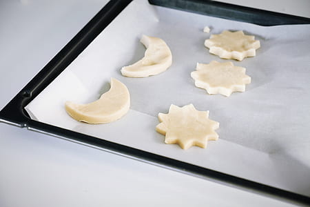 five star and moon cookies on black oven pan thumbnail