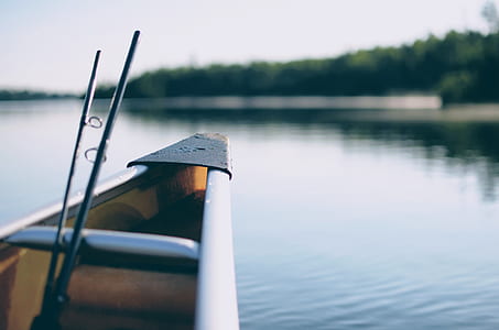 two fishing rods on grey canoe at daytime thumbnail