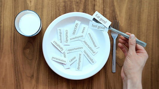 eat good text print on white paper strip on spoon thumbnail