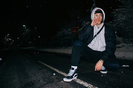 man sitting on road holding cigarette thumbnail