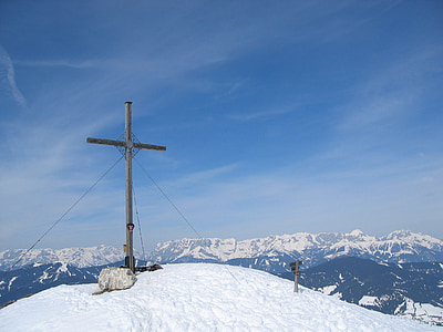 gray cross on top of snow covered mountain thumbnail