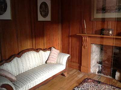 white padded sofa near fireplace thumbnail