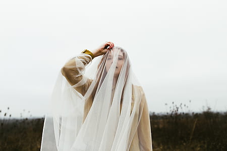 woman holding white mesh veil thumbnail