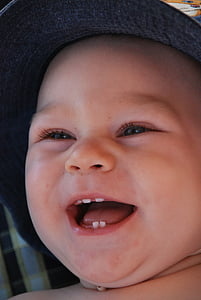 smiling baby wearing gray hat thumbnail