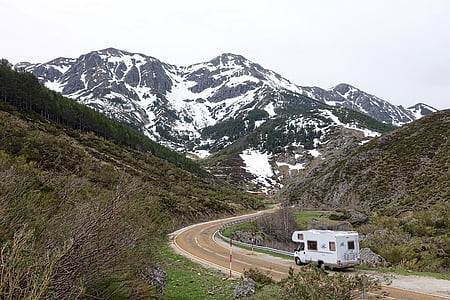 white class C motor home traveling on road thumbnail