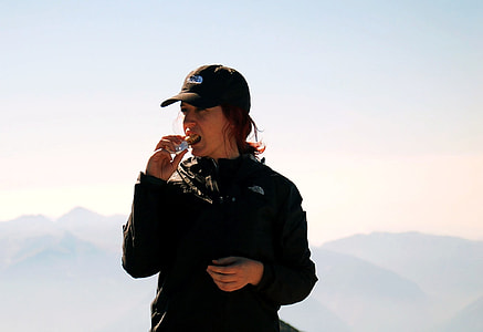 woman in black jacket and hat under blue sky during daytime thumbnail