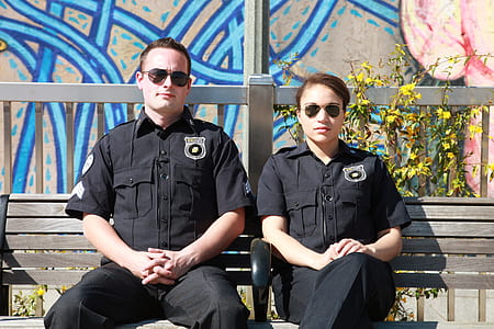 two male and female police sitting on bench thumbnail