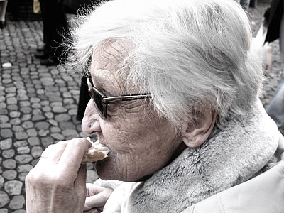woman eating bread close-up photo thumbnail