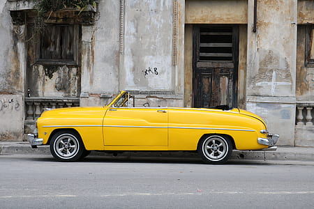 yellow convertible parked near building thumbnail