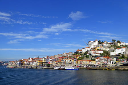 villages near sea under white and blue skies at daytime thumbnail