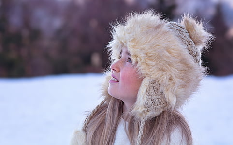woman in beige Russian cap looking up on snow covered ground thumbnail