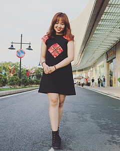 Woman Wearing Black and Red Cap-sleeved Crew-neck Dress and Black High-top Sneakers thumbnail